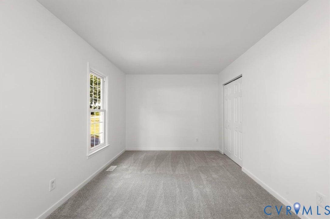 3031 Speeks Drive, Midlothian, VA 23112 Wall-to-wall carpeting with light-toned walls, a single-pane window, and a bi-fold closet door