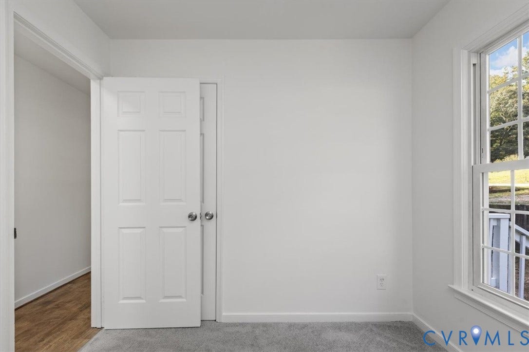 3031 Speeks Drive, Midlothian, VA 23112 Wall-to-wall carpeting, white interior walls, white paneled door, and a single-hung window with exterior scenery