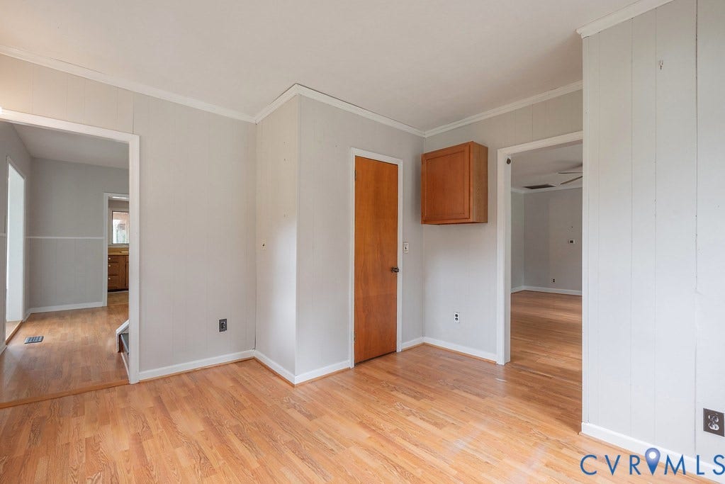 Wood-finish flooring throughout, light gray wall paint, and white trim accents