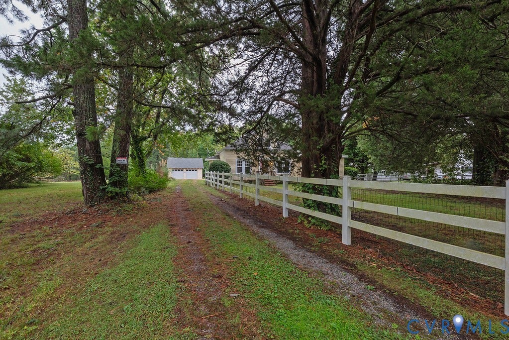 Gravel driveway leading to a detached two-car garage