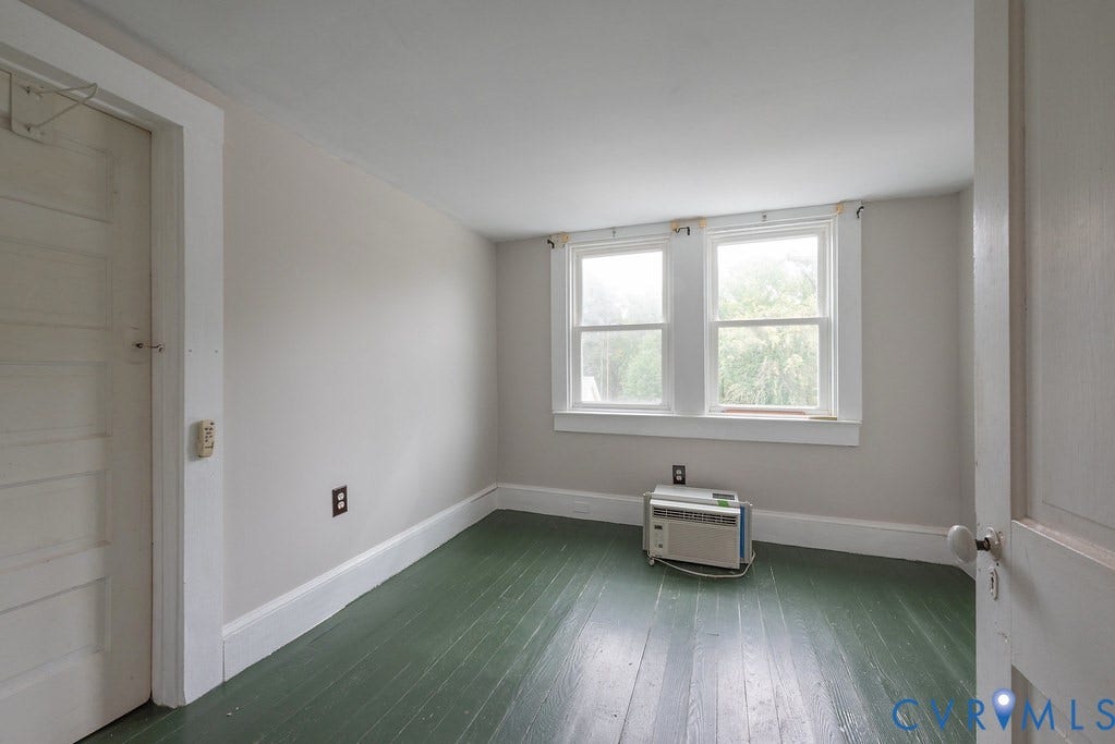 Painted wood flooring, white walls, and white trim