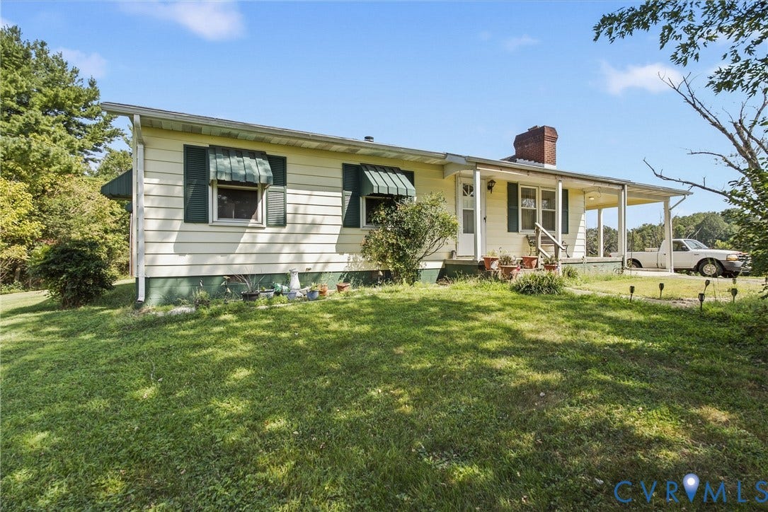117 Gardners Road, Cross County Area, Mineral, VA 23117 Ranch-style exterior with horizontal siding, covered front porch, and brick chimney