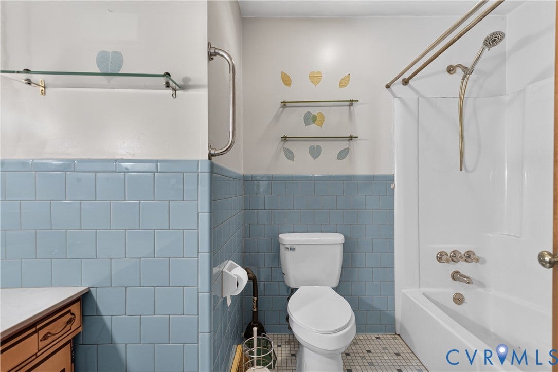 117 Gardners Road, Cross County Area, Mineral, VA 23117 Full bathroom featuring blue wall tiling, a white bathtub with shower, a toilet, and a vanity with a white countertop