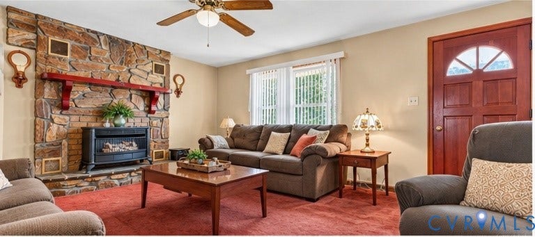 117 Gardners Road, Cross County Area, Mineral, VA 23117 Stone-clad fireplace with mantel, ceiling fan, natural light from a window, and a paneled entry door