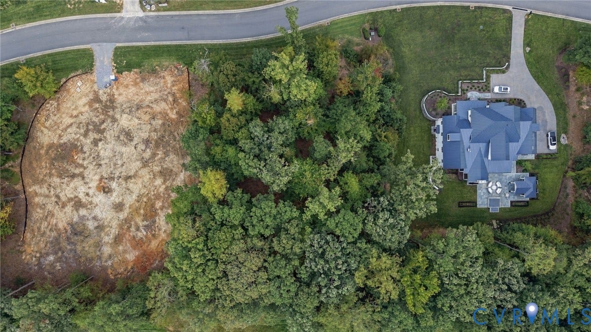 923 Kinloch Point Lane, Kinloch, Manakin Sabot, VA 23103 Expansive lot featuring mature trees, a multi-gabled roofline, stone paving, and a curvilinear driveway