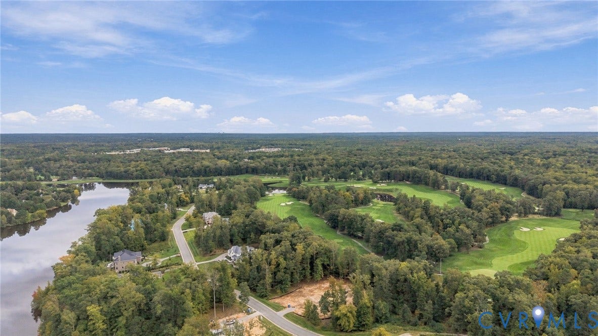 923 Kinloch Point Lane, Kinloch, Manakin Sabot, VA 23103 Expansive natural setting featuring a prominent body of water, lush green golf course, and dense surrounding woodlands