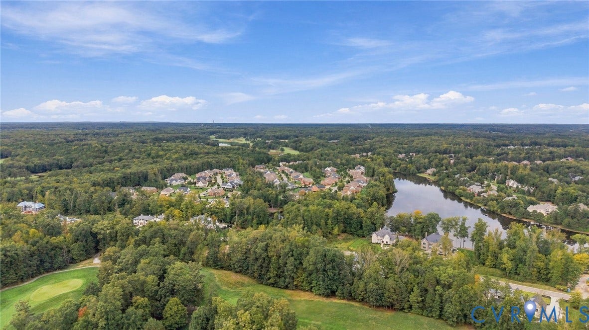 923 Kinloch Point Lane, Kinloch, Manakin Sabot, VA 23103 Aerial perspective featuring a residential area, a body of water, and extensive tree coverage