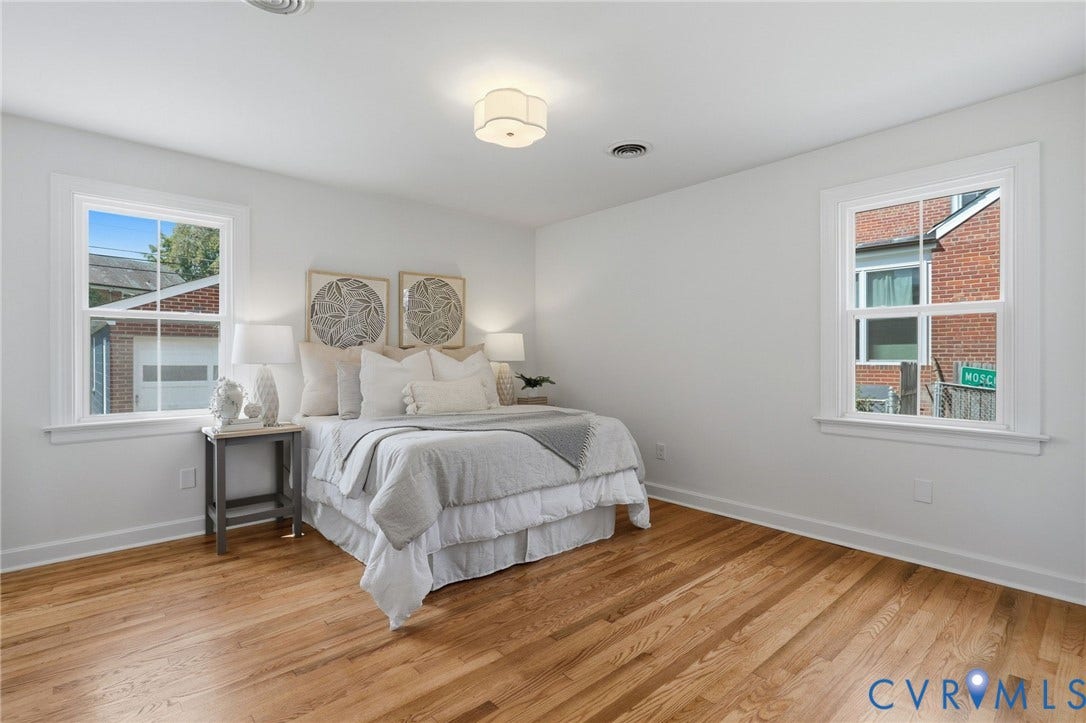 Hardwood flooring, white walls, and a ceiling-mounted light fixture