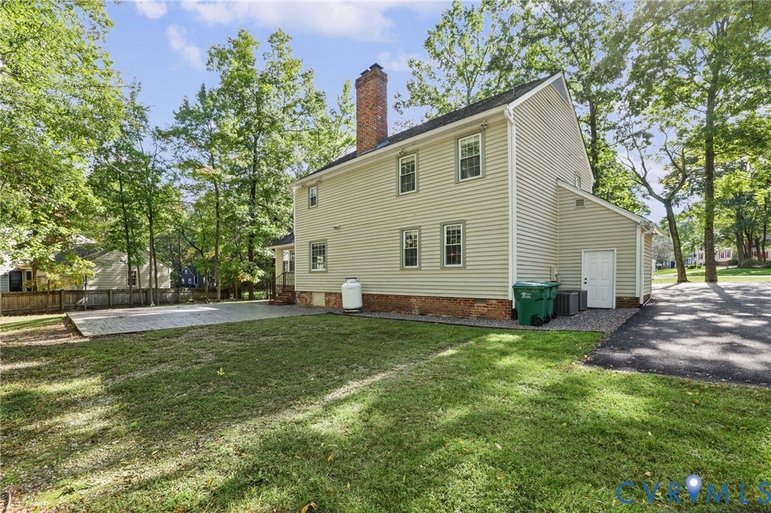 An expansive lawn stretches across the generous corner homesite, offering plenty of room for outdoor enjoyment.