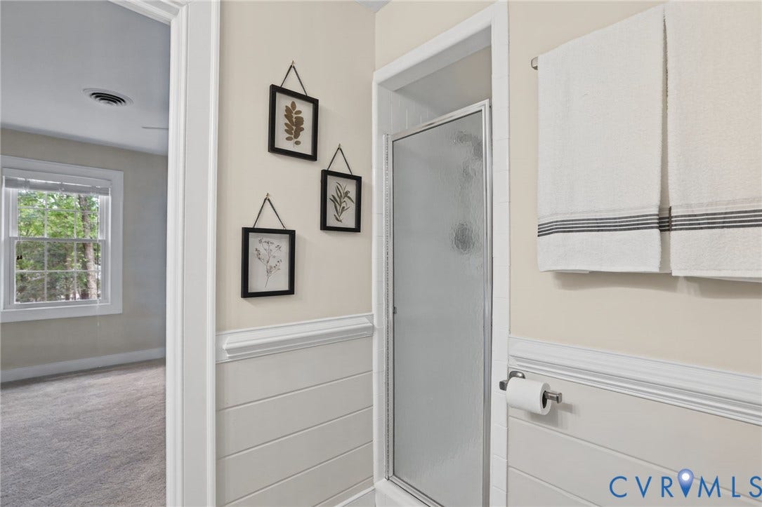 A conveniently arranged Jack-and-Jill bathroom connects the two spacious secondary bedrooms.
