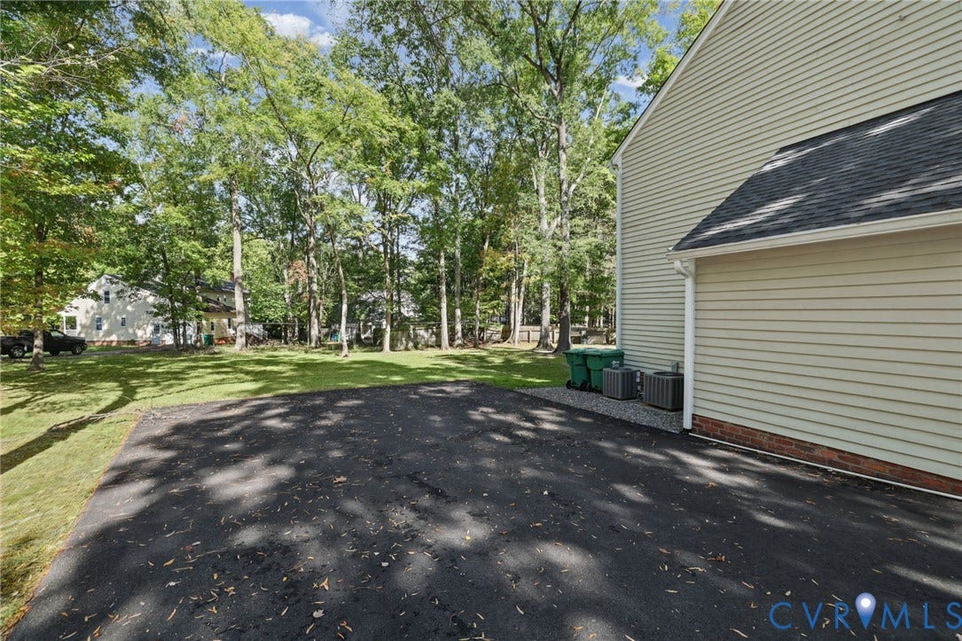 An oversized paved driveway offers generous parking while complementing the home's traditional exterior.
