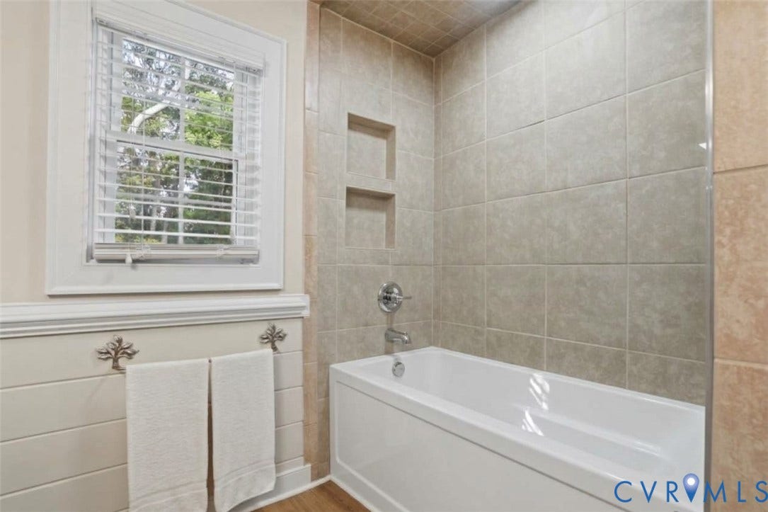 AI generated image showing a bathtub could be easily installed in place of the stall shower.