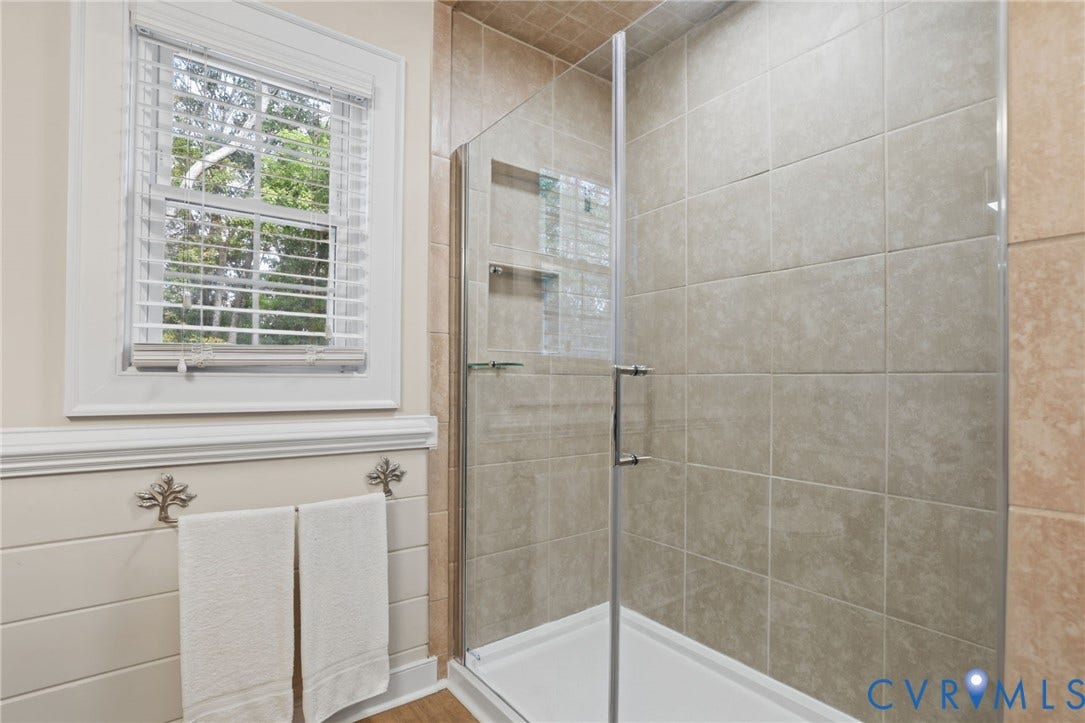 njoy pretty architectural details, new flooring, a freshly painted vanity and updated fixtures in your primary bathroom.