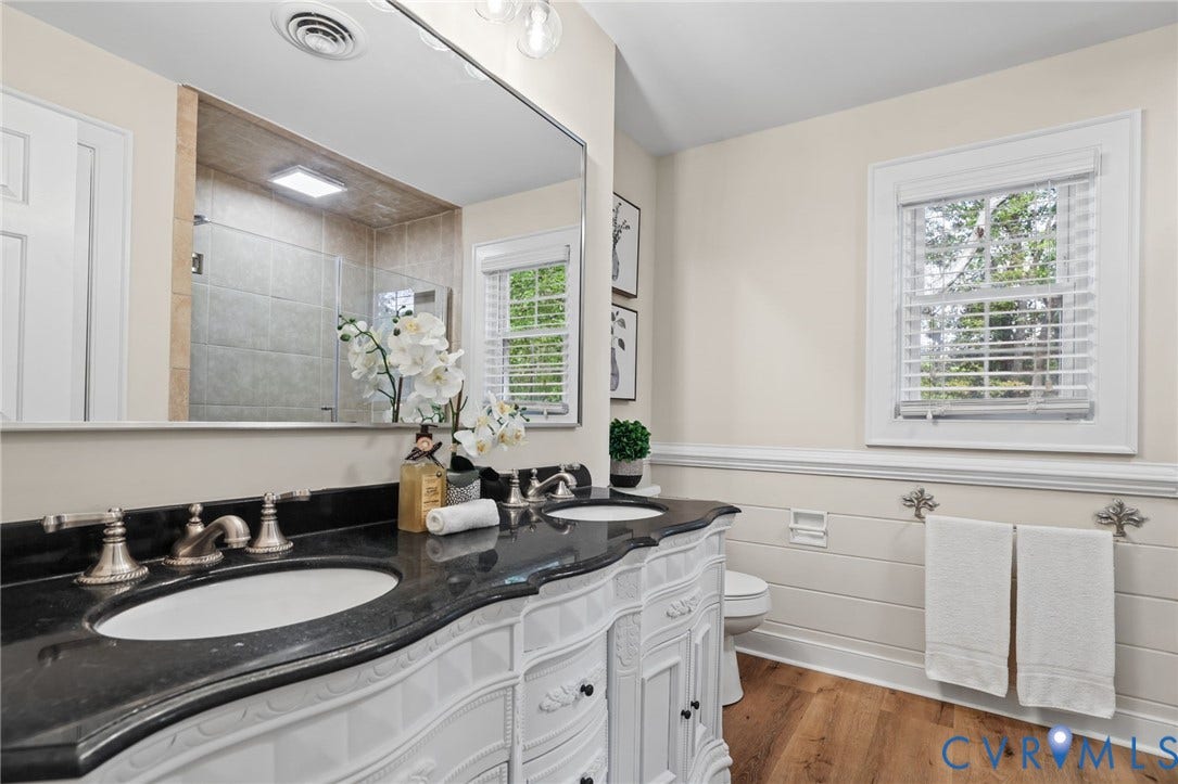 Enjoy pretty architectural details, new flooring, a freshly painted vanity and updated fixtures in your primary bathroom.
