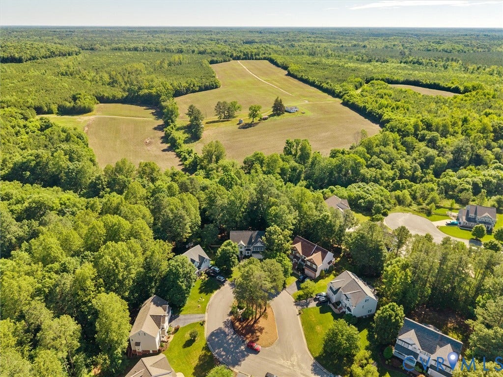 Expansive green landscape with numerous mature trees
