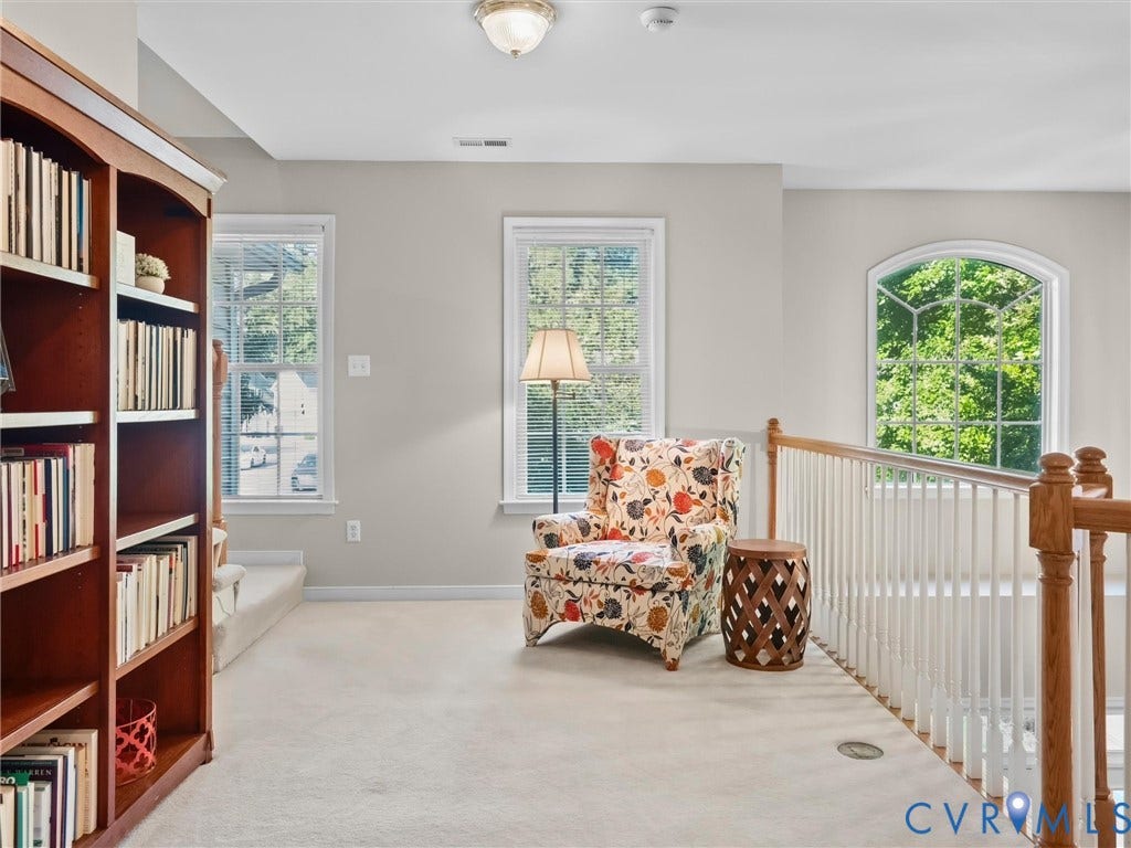 Built-in wood bookcase, arched window, and balustrade railing