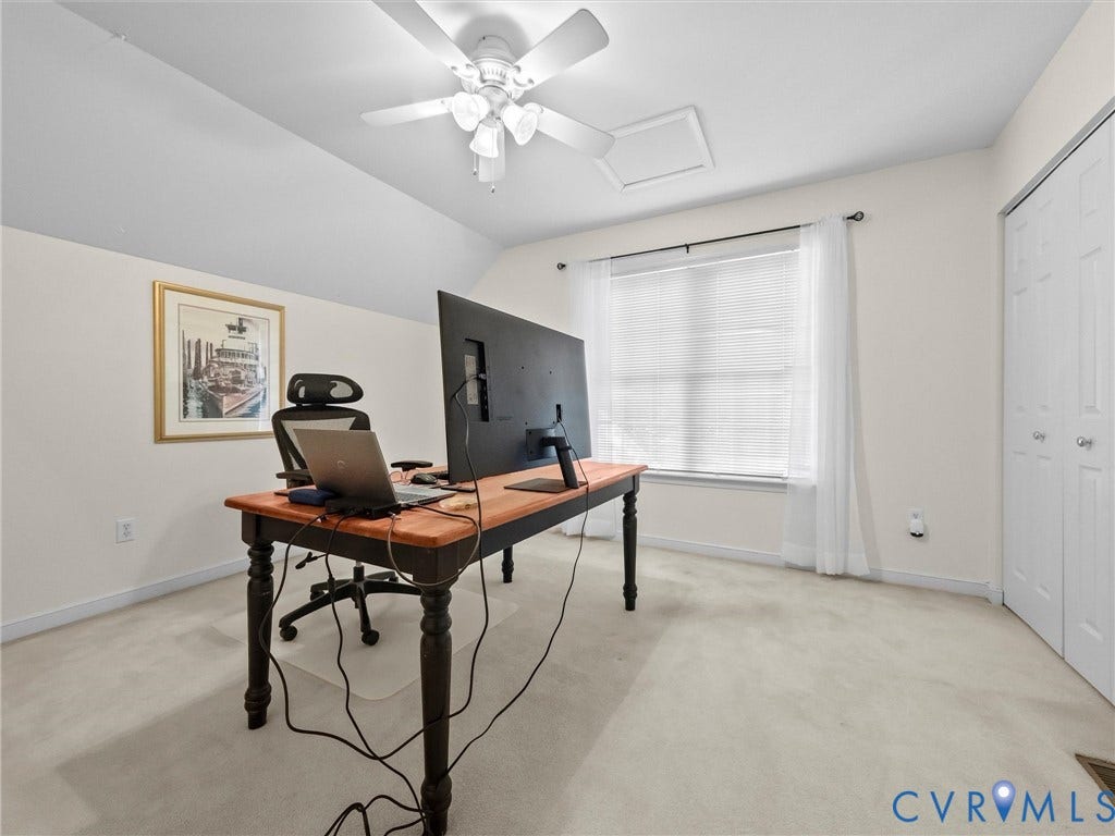 Sloped ceiling design, recessed ceiling access panel, ceiling fan, carpeted flooring, and a double-door closet