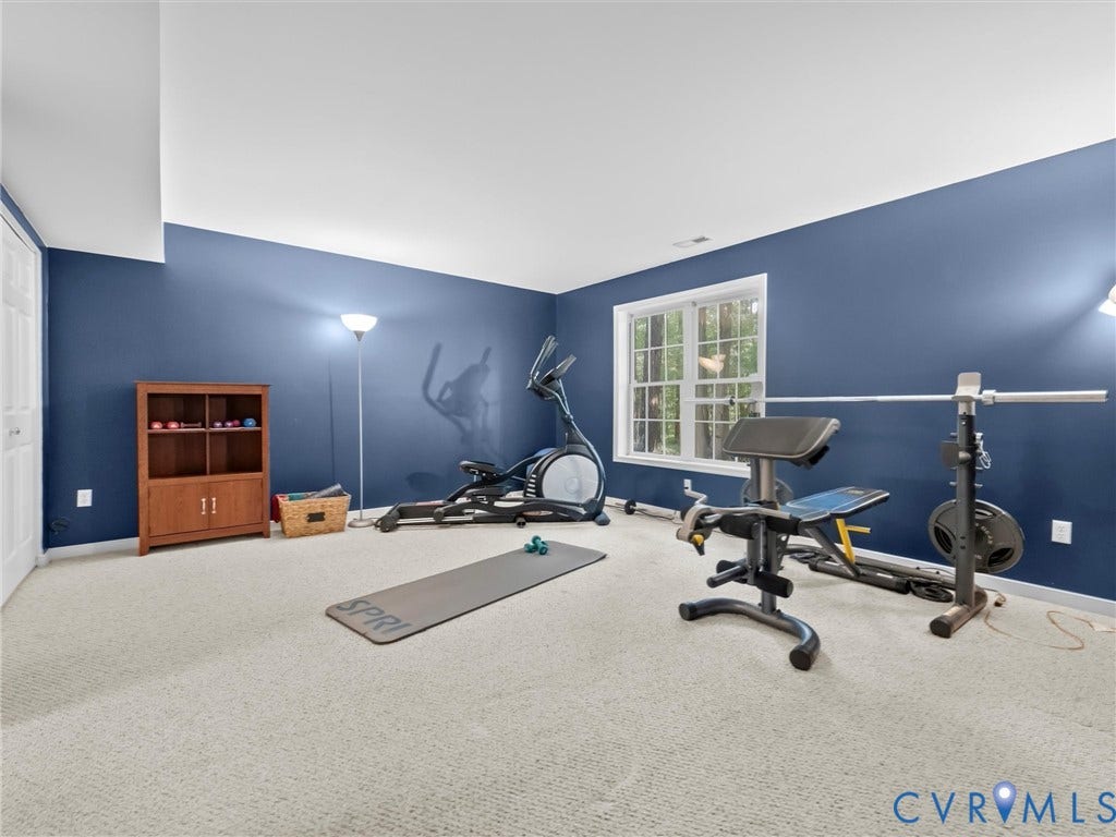 Carpeted room with a double-paned window and white trim