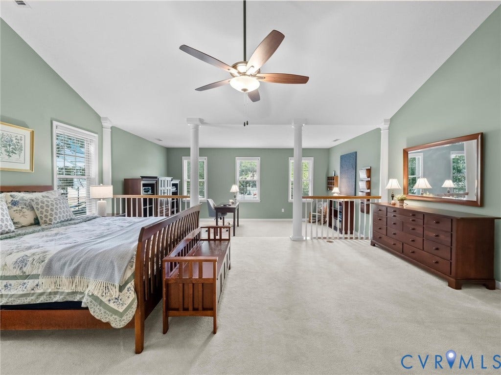 Expansive open-concept room with vaulted ceilings, recessed lighting, and a ceiling fan