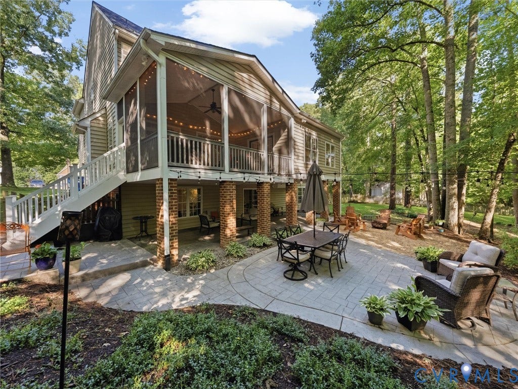 Expansive screened porch, multi-level stamped concrete patio, lower-level covered patio, and established trees