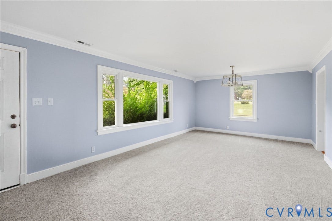 5901 Bonneau Road, Richmond, VA 23227 Expansive room with neutral carpeting, crown molding, and a modern rectangular chandelier