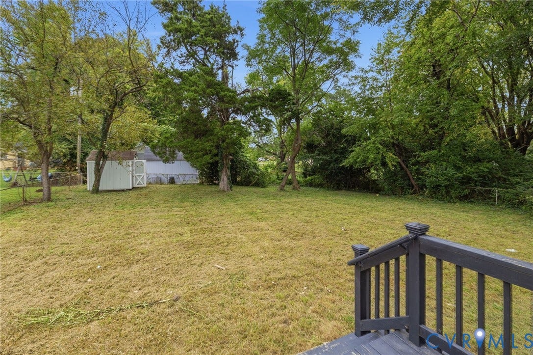 5901 Bonneau Road, Richmond, VA 23227 Expansive grassy yard with mature trees and a white storage shed