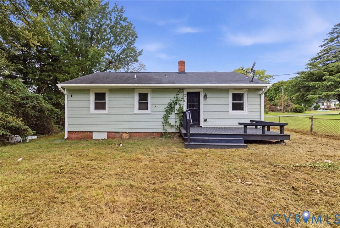 5901 Bonneau Road, Richmond, VA 23227 Expansive backyard featuring a dark-stained deck, light-colored siding, and a brick foundation