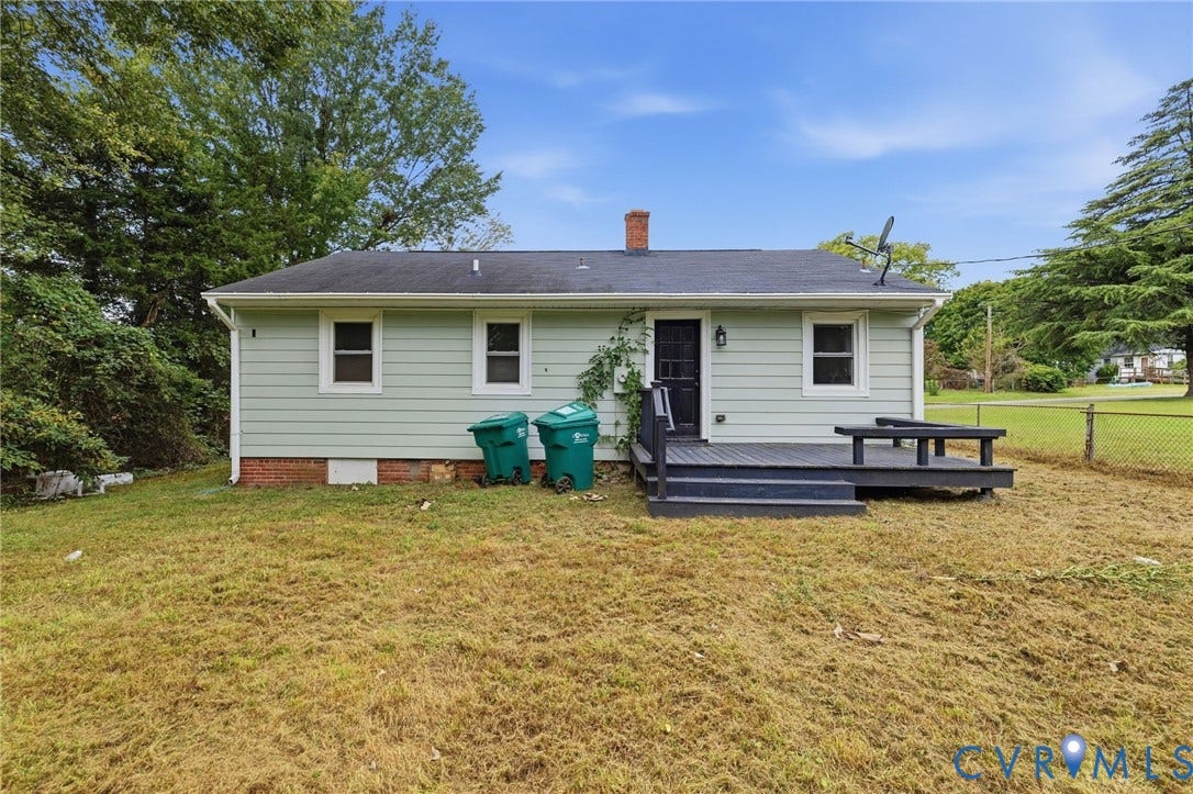 5901 Bonneau Road, Richmond, VA 23227 Light green horizontal siding exterior with a dark-stained wood deck, featuring a built-in bench