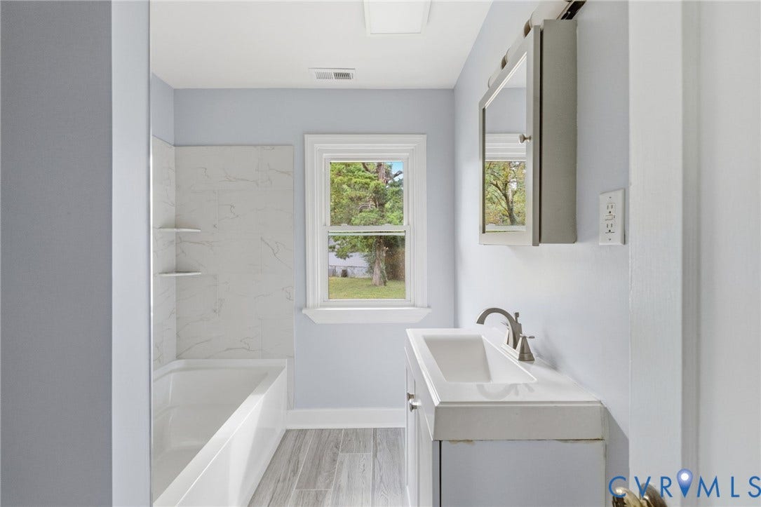 5901 Bonneau Road, Richmond, VA 23227 Bathroom with a built-in tub/shower combination, integrated shelving, and a vanity with a rectangular sink