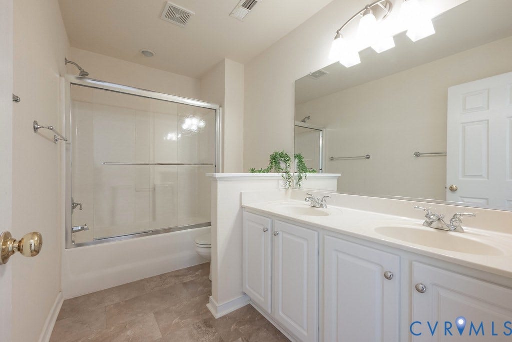 Full bath in hall new flooring, double vanity