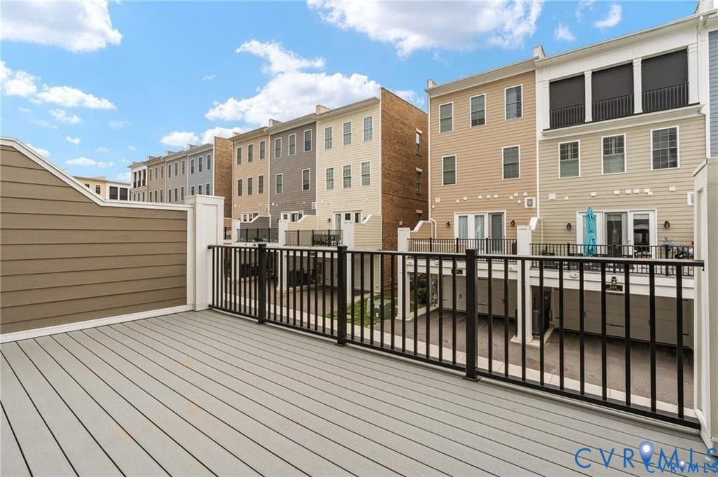 Low-maintenance decking and privacy partitions create space for outdoor dining and relaxing.