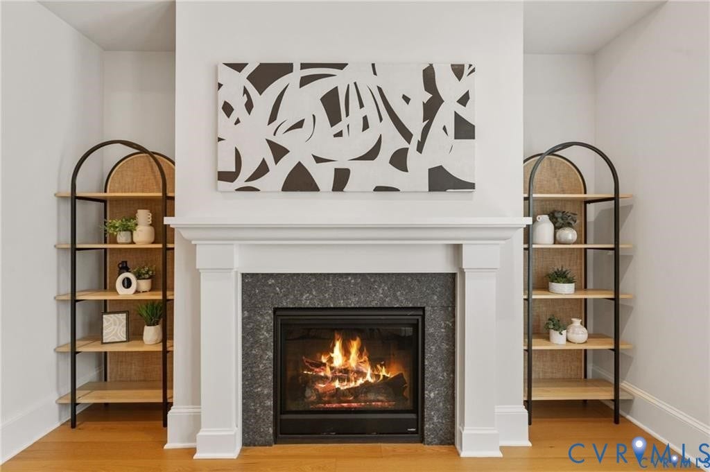 A fireplace with a substantial white mantel creates a beautiful living room focal point.