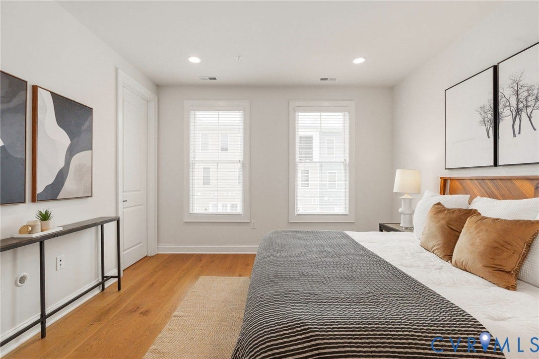 Natural light and a tray ceiling give the primary bedroom an airy, restful feel.