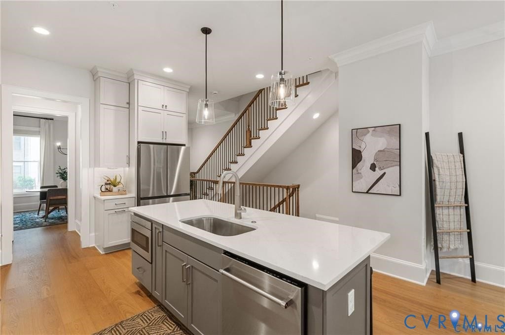 Pendant lighting highlights the expansive island with an integrated sink and ample prep space.