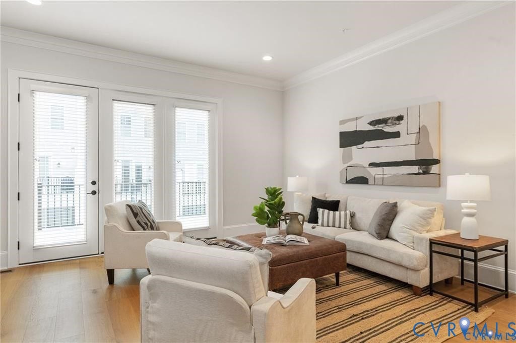 Tall windows and glass deck doors fill the living room with natural light.