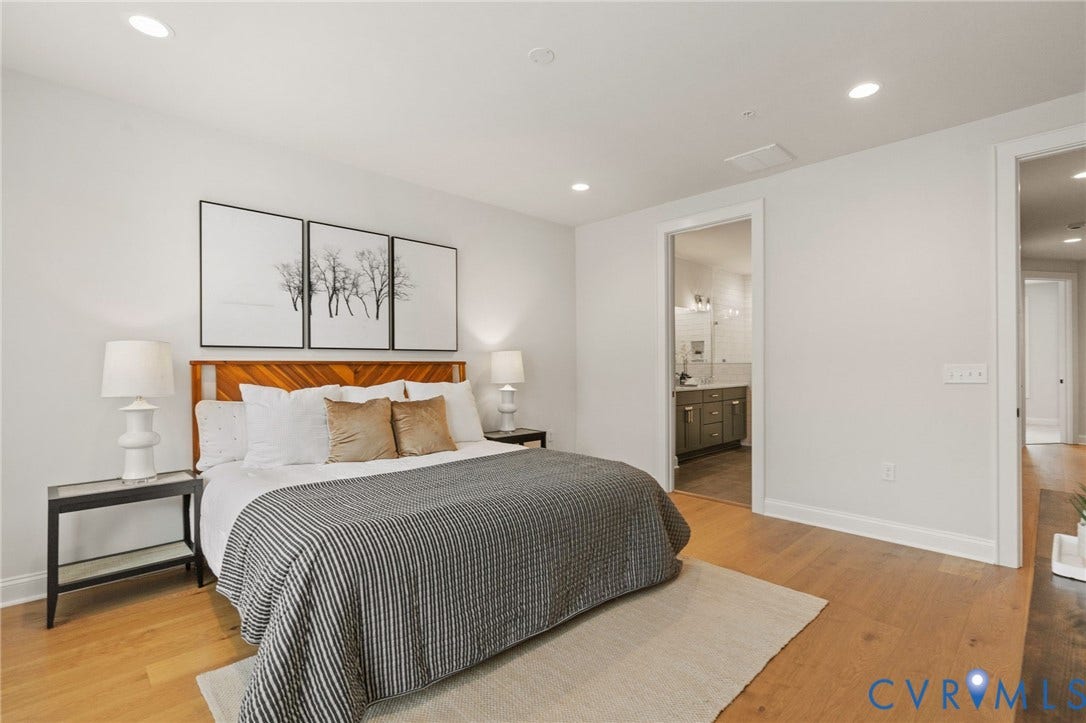 The generous primary suite offers room for a king-size bed and additional furnishings.