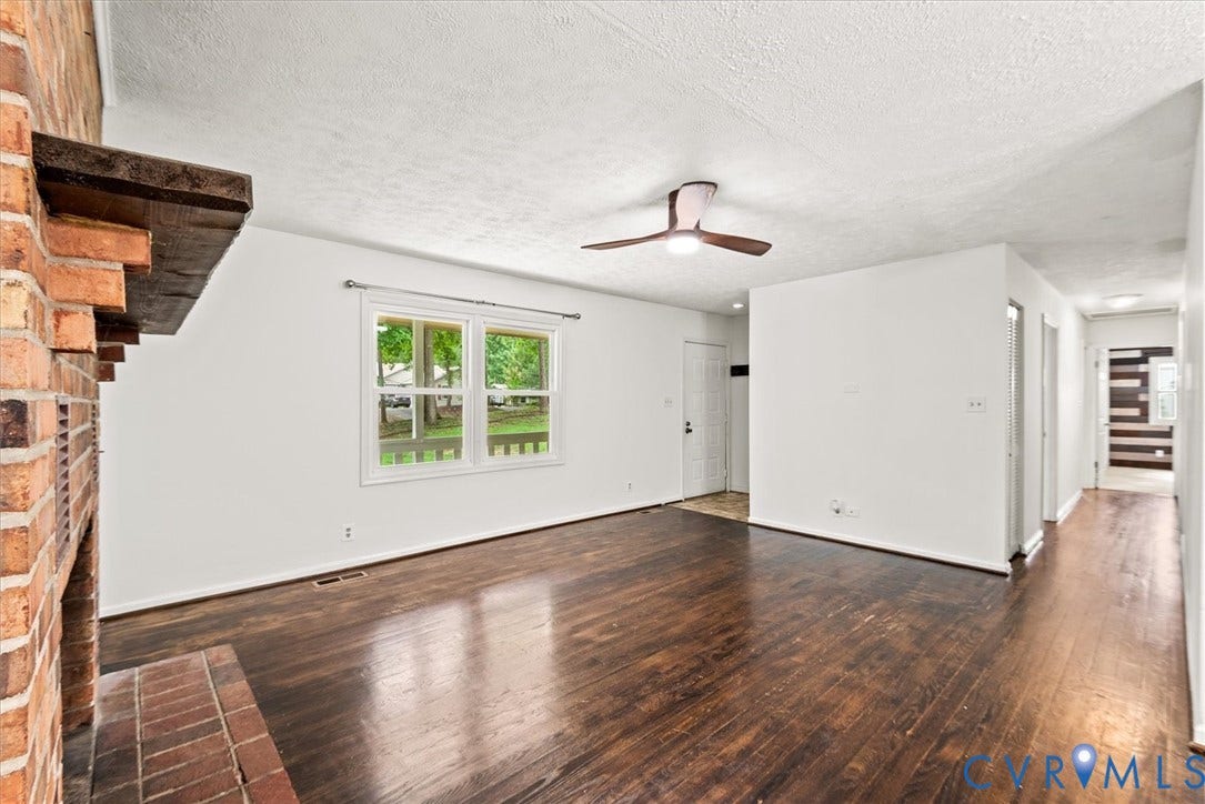Brick fireplace with a substantial wood mantel