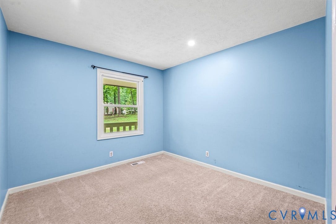 Recessed ceiling lighting, light blue wall finishes, white trim, and neutral carpet flooring