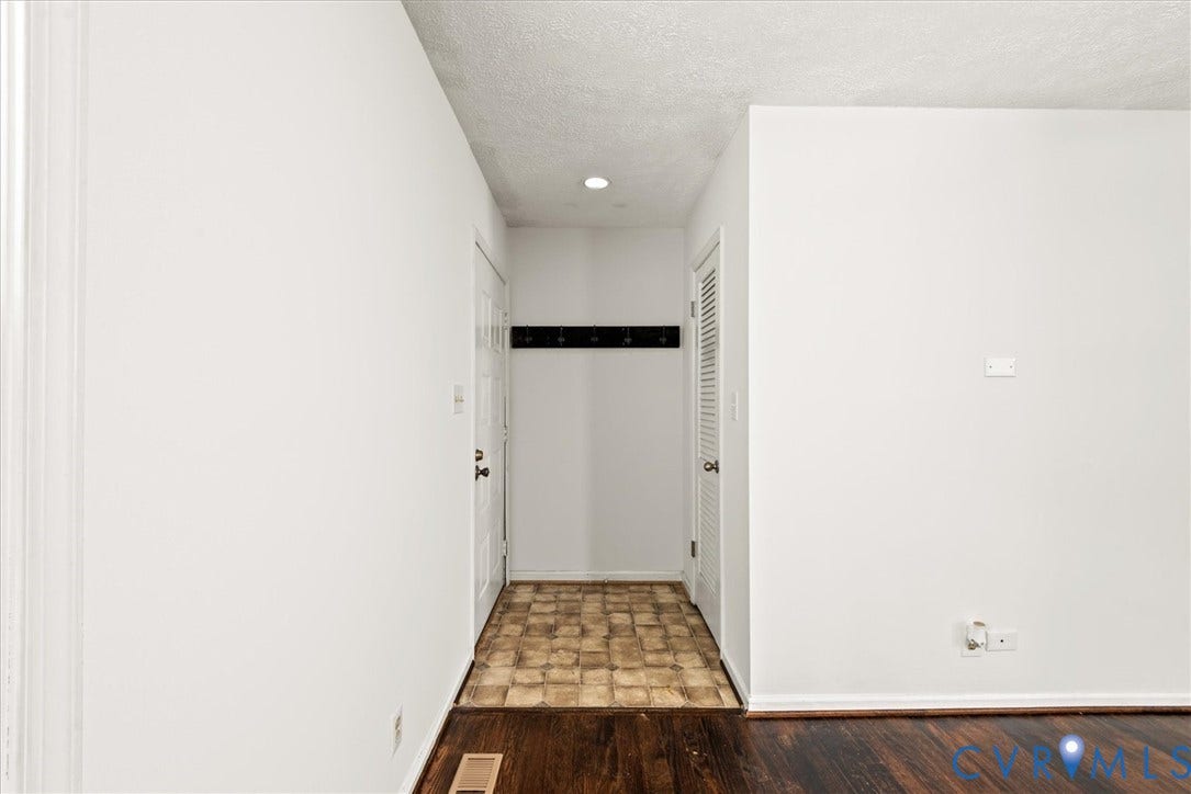 Entryway featuring wood-finish flooring, white walls, and a recessed ceiling light