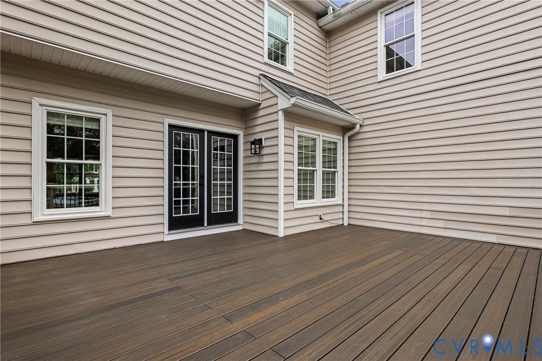 11100 Glen Hollow Court, Henrico, VA 23233 Spacious outdoor deck with wood-finish planks, dual-pane windows, and a black exterior light fixture