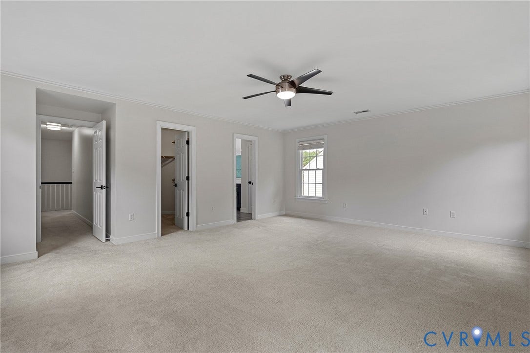 11100 Glen Hollow Court, Henrico, VA 23233 Spacious room with light-toned carpeting, ceiling fan with integrated lighting, multiple doorways, and a window with white trim