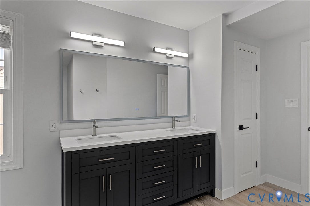 11100 Glen Hollow Court, Henrico, VA 23233 Dual vanity with a white countertop and rectangular undermount sinks, flanked by modern wall-mounted light fixtures