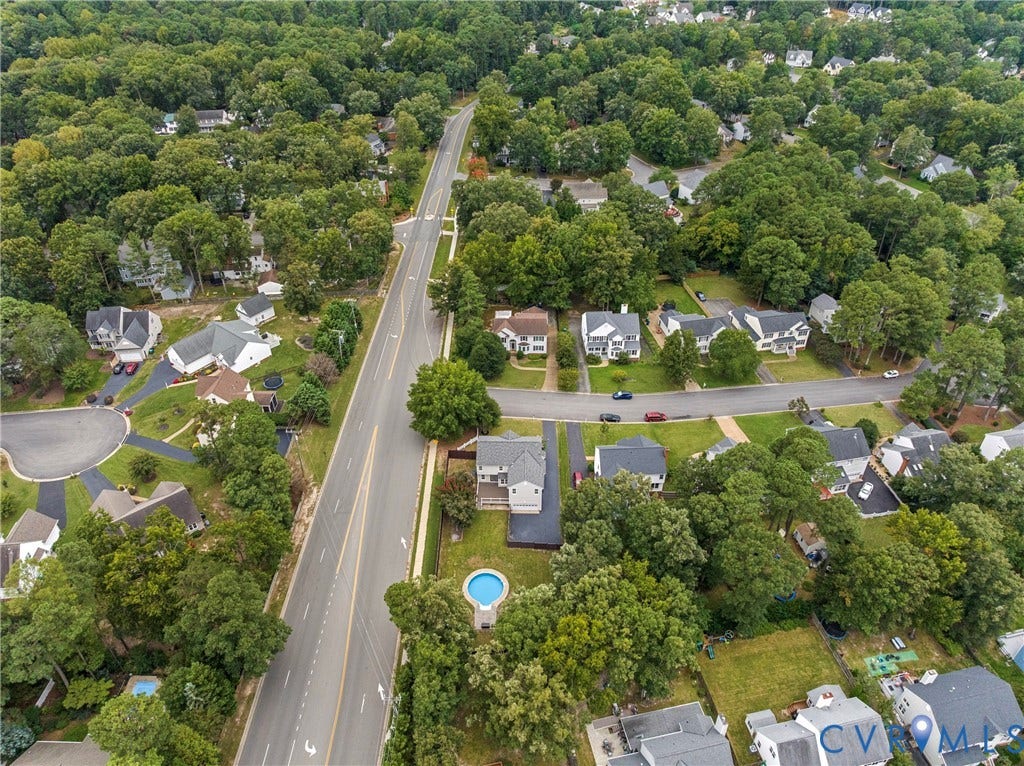 11100 Glen Hollow Court, Henrico, VA 23233 Aerial perspective showcasing a residential neighborhood with mature trees, paved roads, and multiple properties with private yards