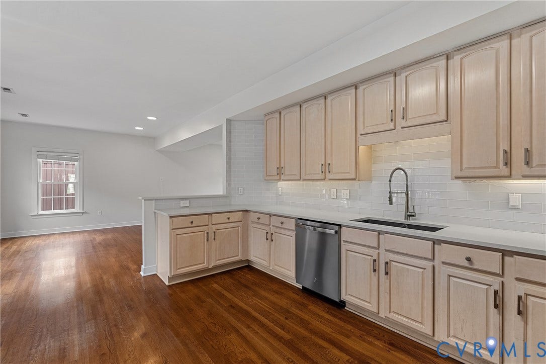 11100 Glen Hollow Court, Henrico, VA 23233 Kitchen featuring light wood-finish cabinetry, solid surface countertops, a subway tile backsplash, and stainless steel dishwasher