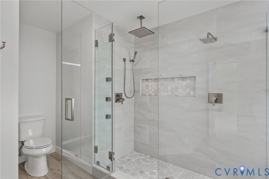 11100 Glen Hollow Court, Henrico, VA 23233 Glass-enclosed shower with a rainfall showerhead, handheld shower, and body sprays