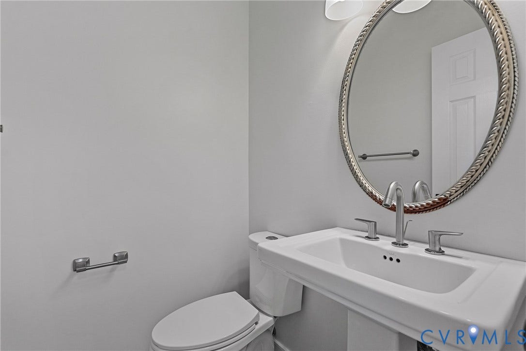 11100 Glen Hollow Court, Henrico, VA 23233 Pedestal sink with a wide basin, polished chrome fixtures, and a decorative oval mirror