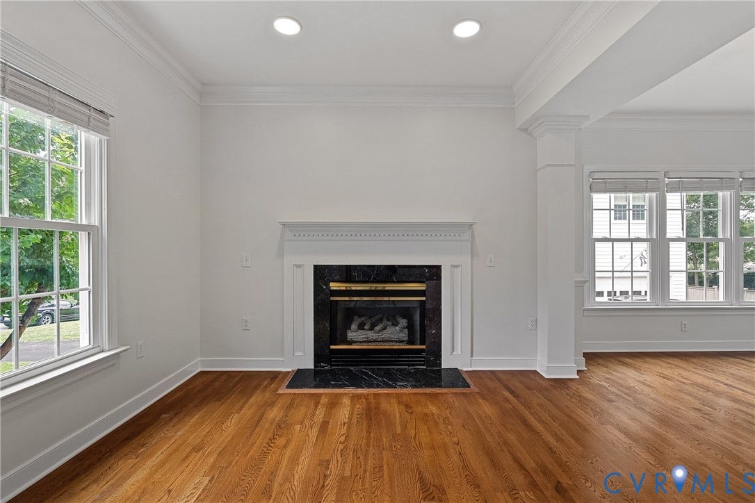 11100 Glen Hollow Court, Henrico, VA 23233 Hardwood flooring, recessed lighting, fireplace with a black stone surround and mantel, and white trim