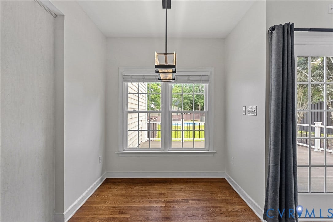 11100 Glen Hollow Court, Henrico, VA 23233 Hardwood flooring, white trim, recessed window with blinds, modern hanging light fixture, and French-style patio door