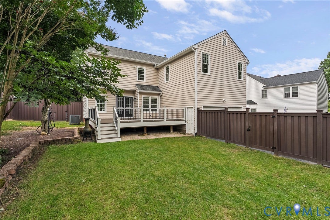 11100 Glen Hollow Court, Henrico, VA 23233 Private backyard featuring a composite deck with black metal railings, a full privacy fence, and a manicured lawn