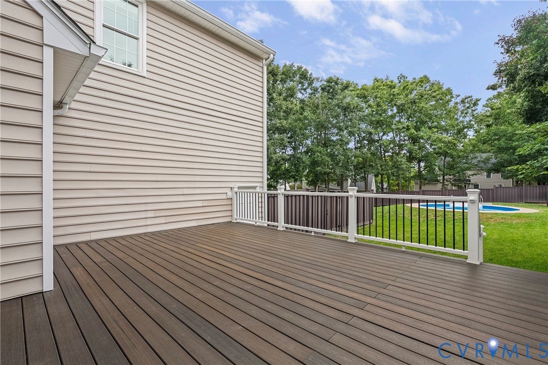 11100 Glen Hollow Court, Henrico, VA 23233 Expansive deck with composite decking and white railing, overlooking a fenced yard with an in-ground pool